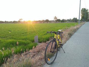 Bicycle on field against clear sky