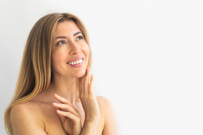 Portrait of young woman against white background