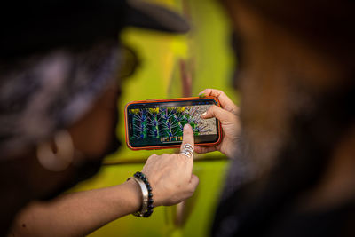 Visual artist who collaborates in painting the mural on the bridge, graffiti street art 