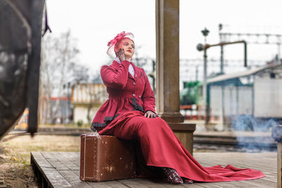 Portrait of woman sitting on street