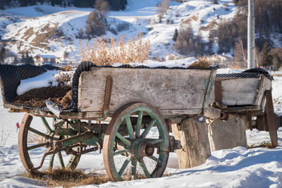 Abandoned cart on snowfield