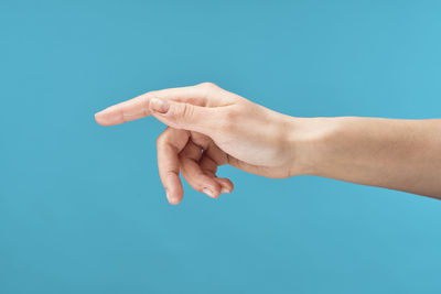 Close-up of hands over blue background