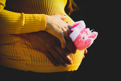 Close-up of human hand against black background