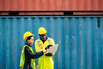 Full length of a man working with mobile phone