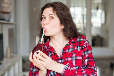 Portrait of smiling woman drinking drink