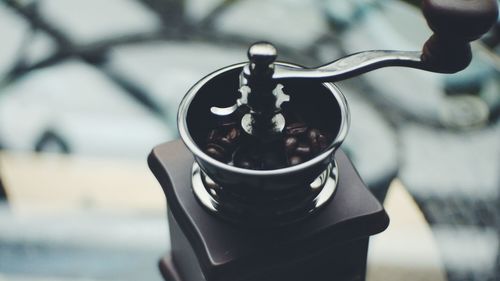 Close-up of coffee maker on glass table