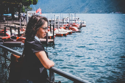 Woman looking at boat in sea