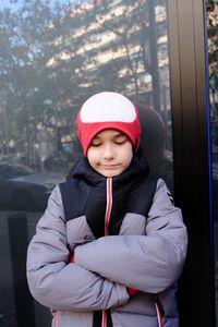 Portrait of smiling girl standing against trees