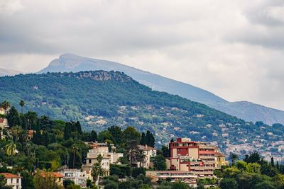 Townscape by mountain against sky