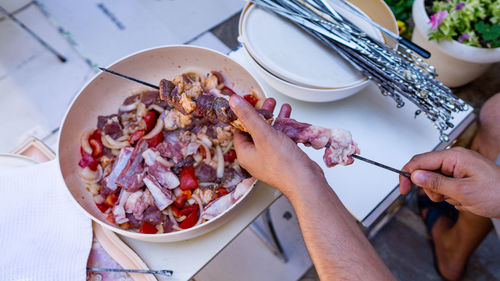 High angle view of person preparing food on table