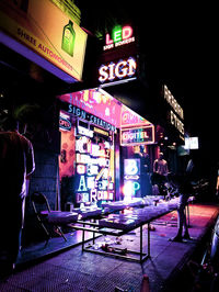 People on illuminated street at night