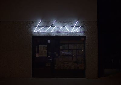 Information sign on wall at night