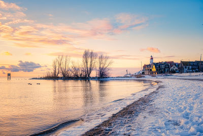 Scenic view of frozen lake against sky during sunset