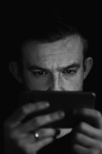 Close-up of man using mobile phone