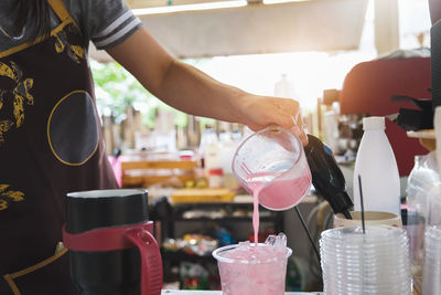 Midsection of person preparing food in kitchen