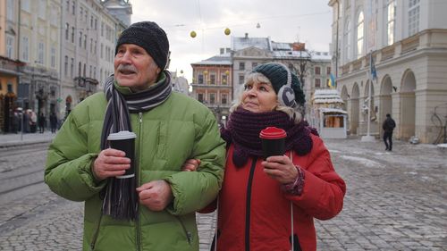 Senior couple walking outdoors during winter