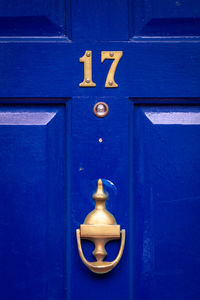 House number 17 on a blue wooden front door