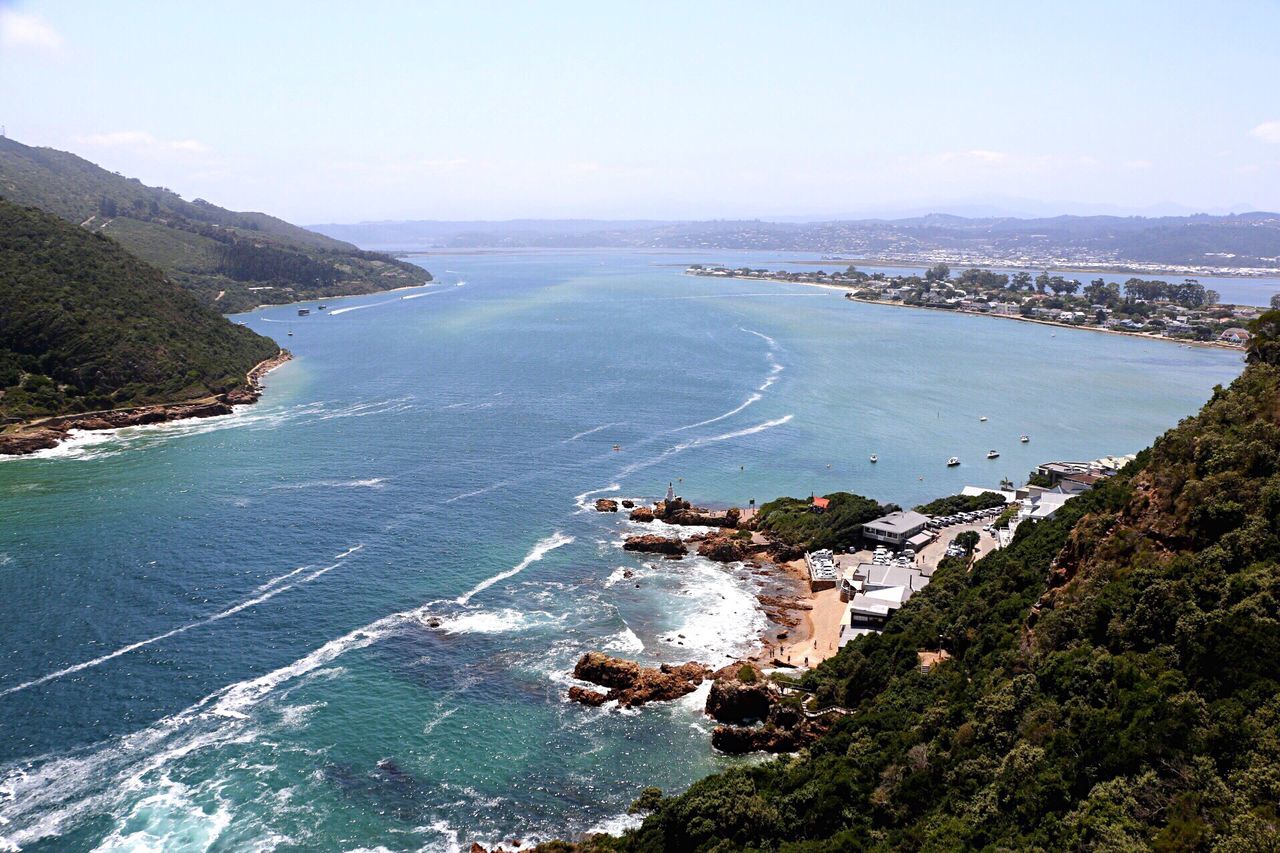 sea, water, horizon over water, high angle view, scenics, tranquil scene, tranquility, beauty in nature, coastline, nature, beach, sky, blue, clear sky, idyllic, day, shore, tree, aerial view, outdoors