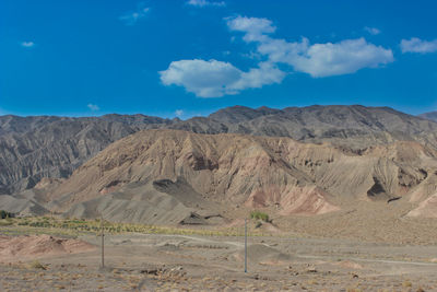 Scenic view of desert against blue sky