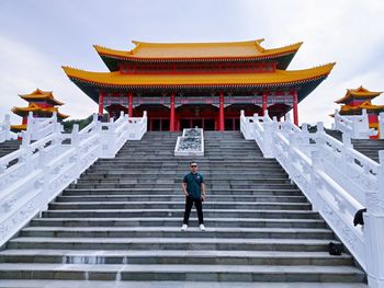 Rear view of man walking on staircase