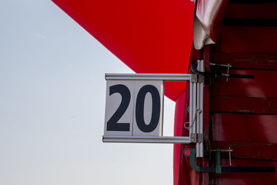 Close-up of information sign against sky