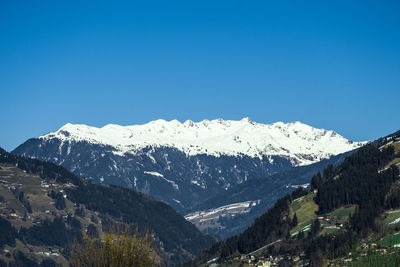 Scenic view of mountains against clear blue sky