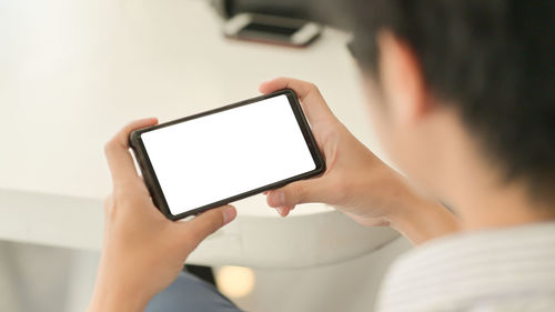 Low section of person using mobile phone