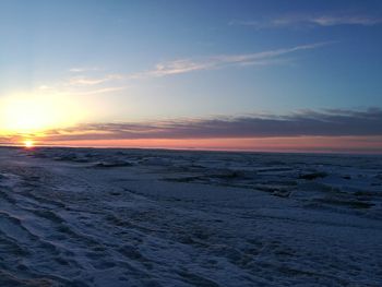 Scenic view of beach against sky during sunset