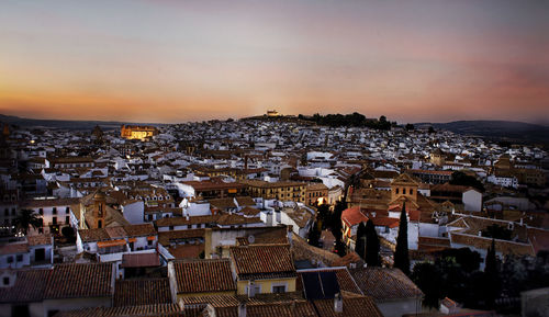 High angle shot of townscape against sky at sunset