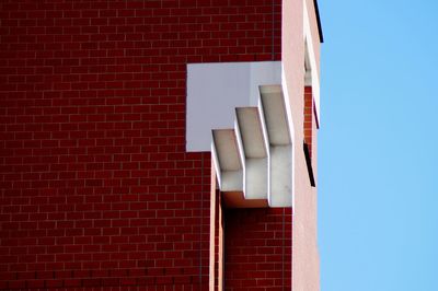 Low angle view of building against clear blue sky