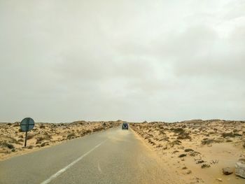 Road on desert against sky