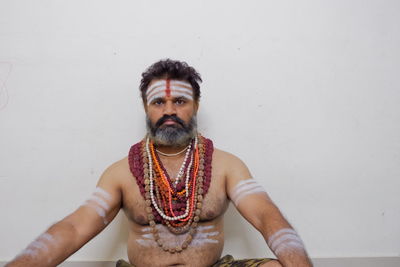 Portrait of man standing against wall