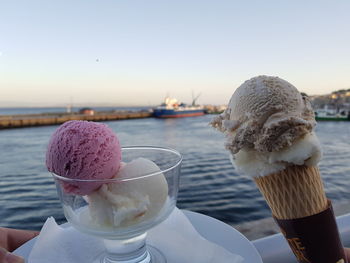 Close-up of ice cream cone against sky