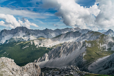 Idyllic shot of rocky mountains against cloudy sky