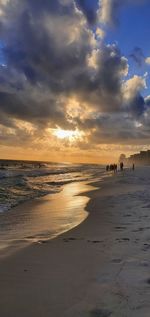 Scenic view of beach against sky during sunset