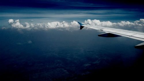 Cropped image of airplane flying over landscape