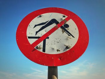 Close-up of sign against blue sky