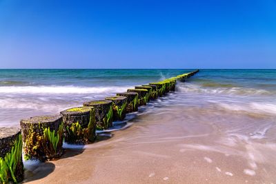 Scenic view of sea against clear blue sky