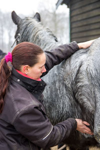 Close-up of woman looking at horse hair