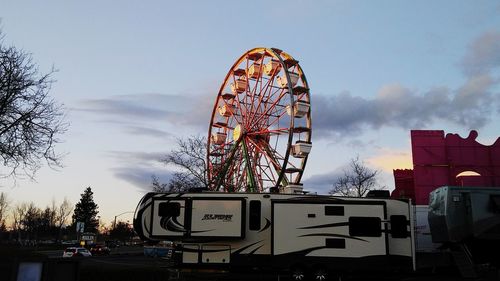 Low angle view of ferris wheel against sky