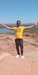 Full length portrait of happy man standing on shore.indian boy enjoying his travelling