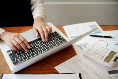 High angle view of woman using laptop on table