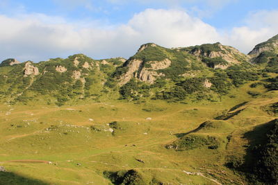 Scenic view of mountains against cloudy sky