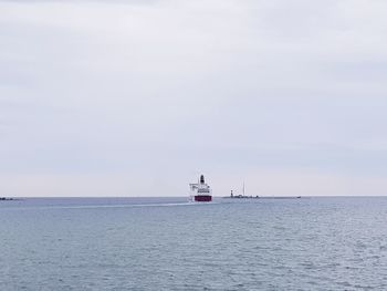 Scenic view of lighthouse by sea against sky