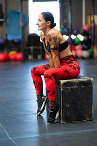 Young woman exercising in gym