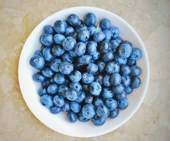 High angle view of blueberries in bowl on table
