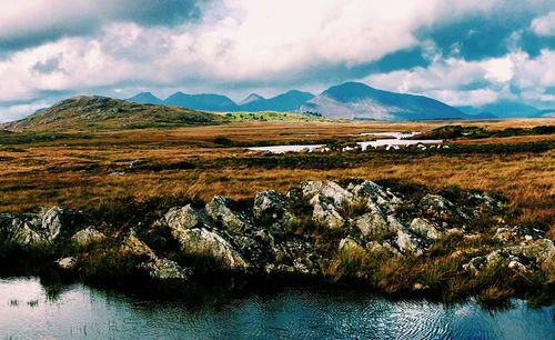 Scenic view of lake and mountains against sky