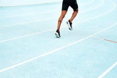 Low section of man running on playing field