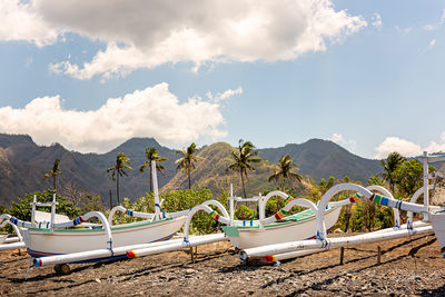 Traditional wooden balinese boats on black sand beach in amed village, bali, indonesia