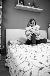 Woman sitting on table at home